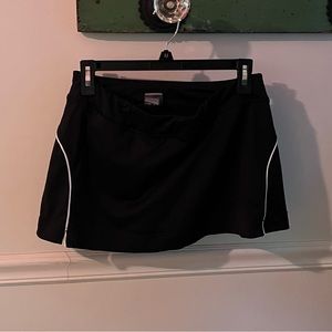Champion golf skort size small. Black with white lines on sides and back.